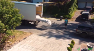 Unloading artificial turf roll from truck