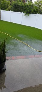 Water pooling on artificial turf due to poor drainage